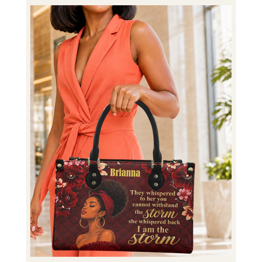 Woman holding I Am the Storm V1 handbag